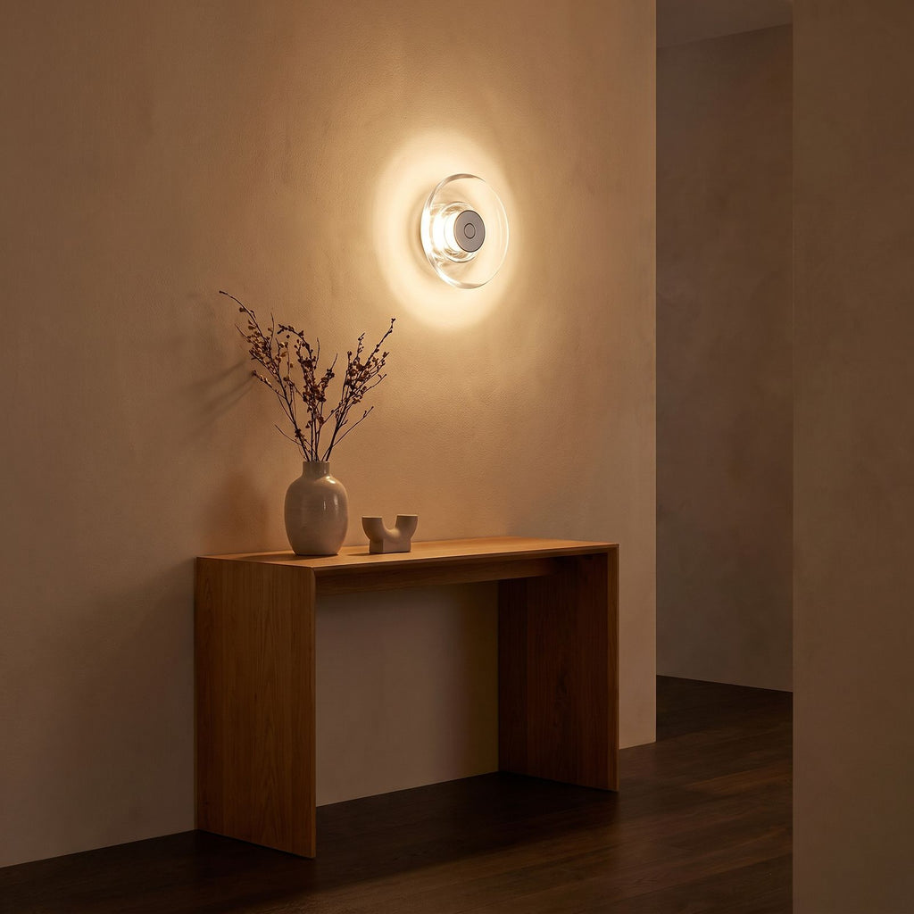 Slim Crystal Disc LED Wall Light in a hallway above a timber console