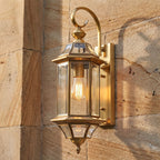 Slim Cylinder Brass Glass Outdoor Wall Light, close view at 45 degrees on a stone wall