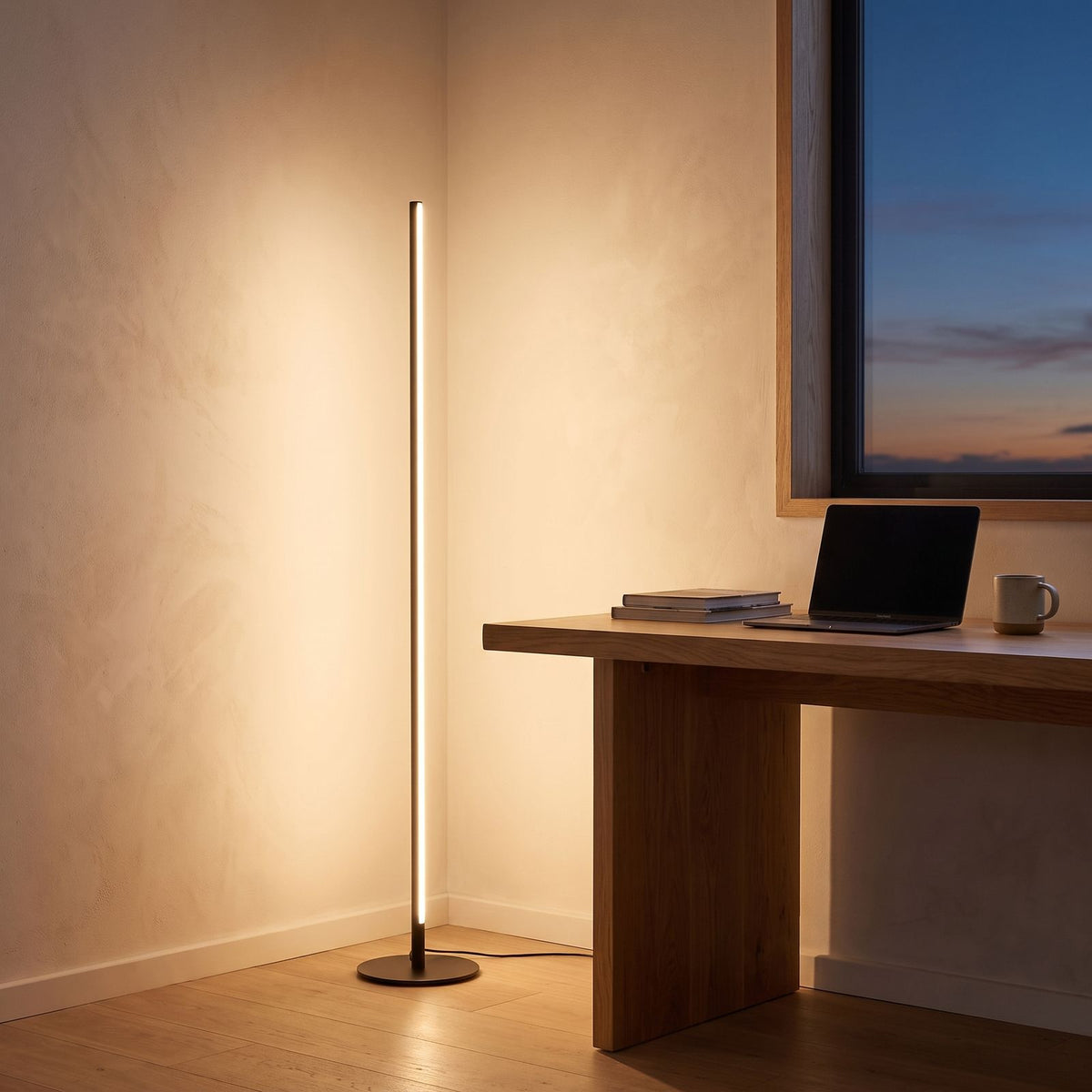 Slim linear LED floor lamp in a home office corner beside a desk