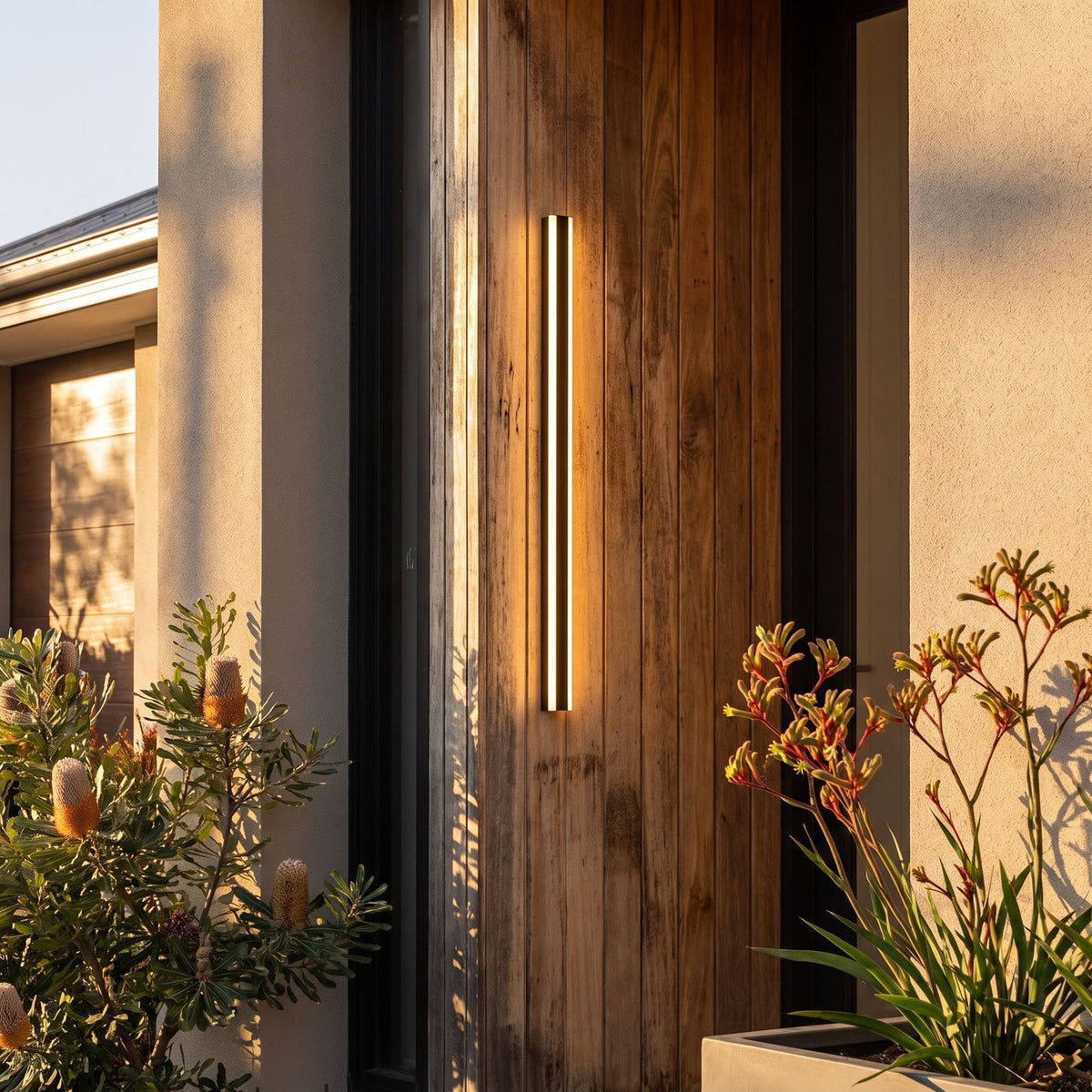Slim Linear Metal Outdoor Wall Light beside a timber front door