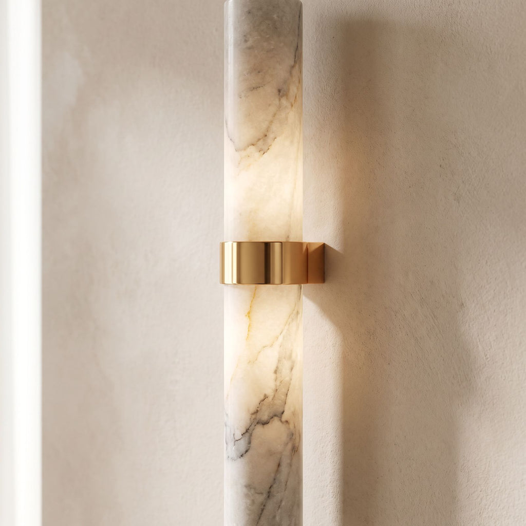 Close view of the natural marble tube and the polished copper bracket