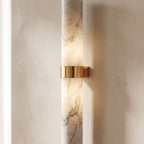Close view of the natural marble tube and the polished copper bracket