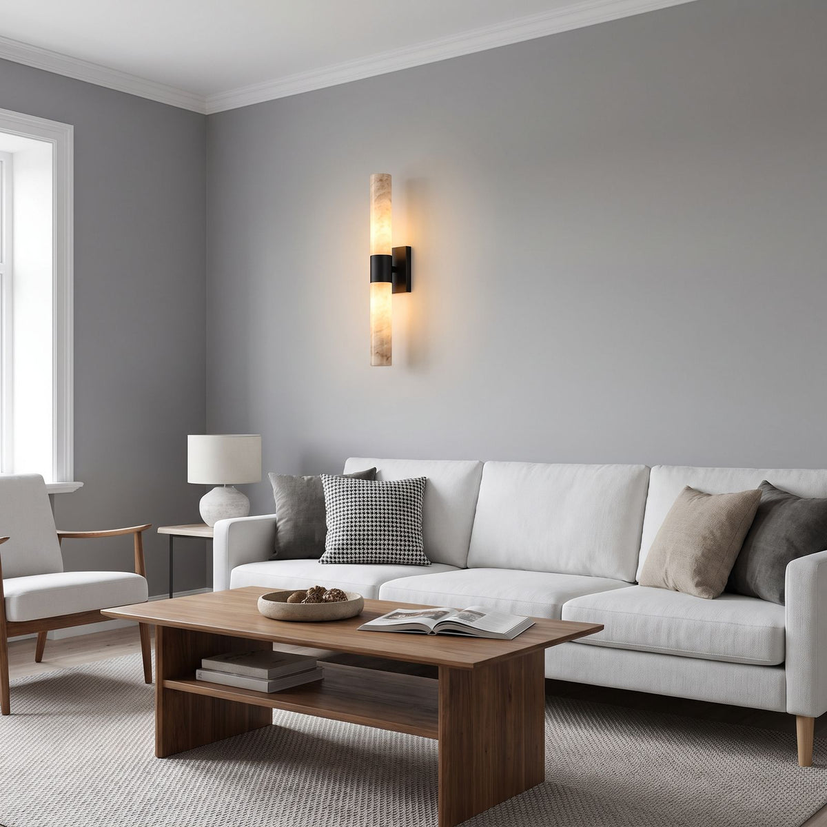 The marble tube wall light in the black finish on a living room wall