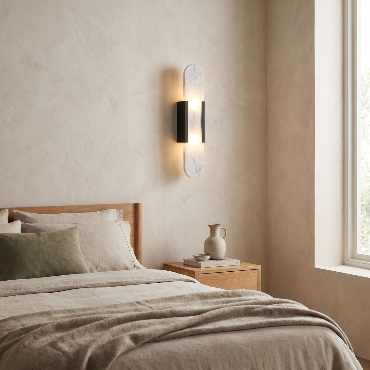 Slim Natural Marble Column Up Down Wall Light on a bedroom wall beside the bed