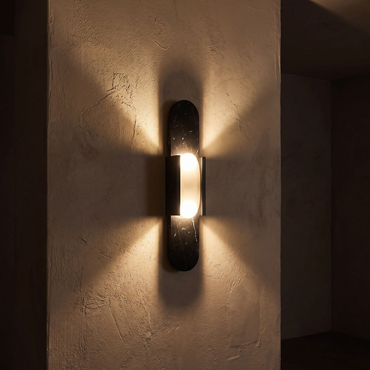 Slim Natural Marble Column Up Down Wall Light glowing on a plaster wall at night