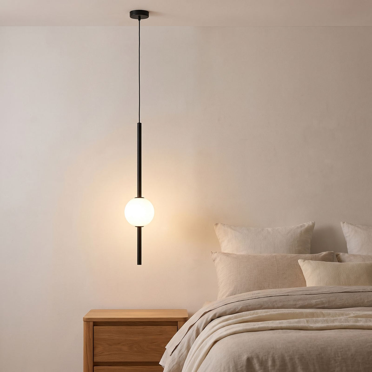 Slim Rod Frosted Glass Ball LED Pendant Light beside a bed