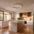 Slim teardrop LED ceiling light in a wide living room view