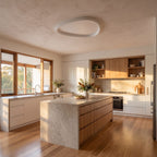Slim teardrop LED ceiling light in a wide living room view