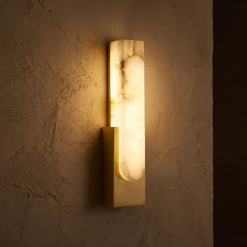 Slim Vertical Alabaster LED Wall Light glowing on a plaster wall at night