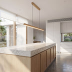 Slim wood bar linear LED pendant light over a kitchen island in daylight