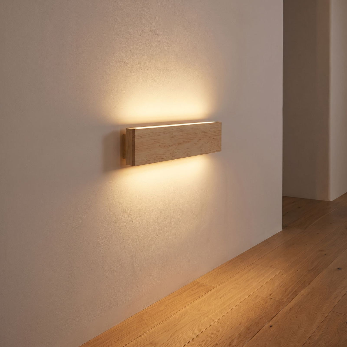 Slim wood plank wall sconce on a hallway wall