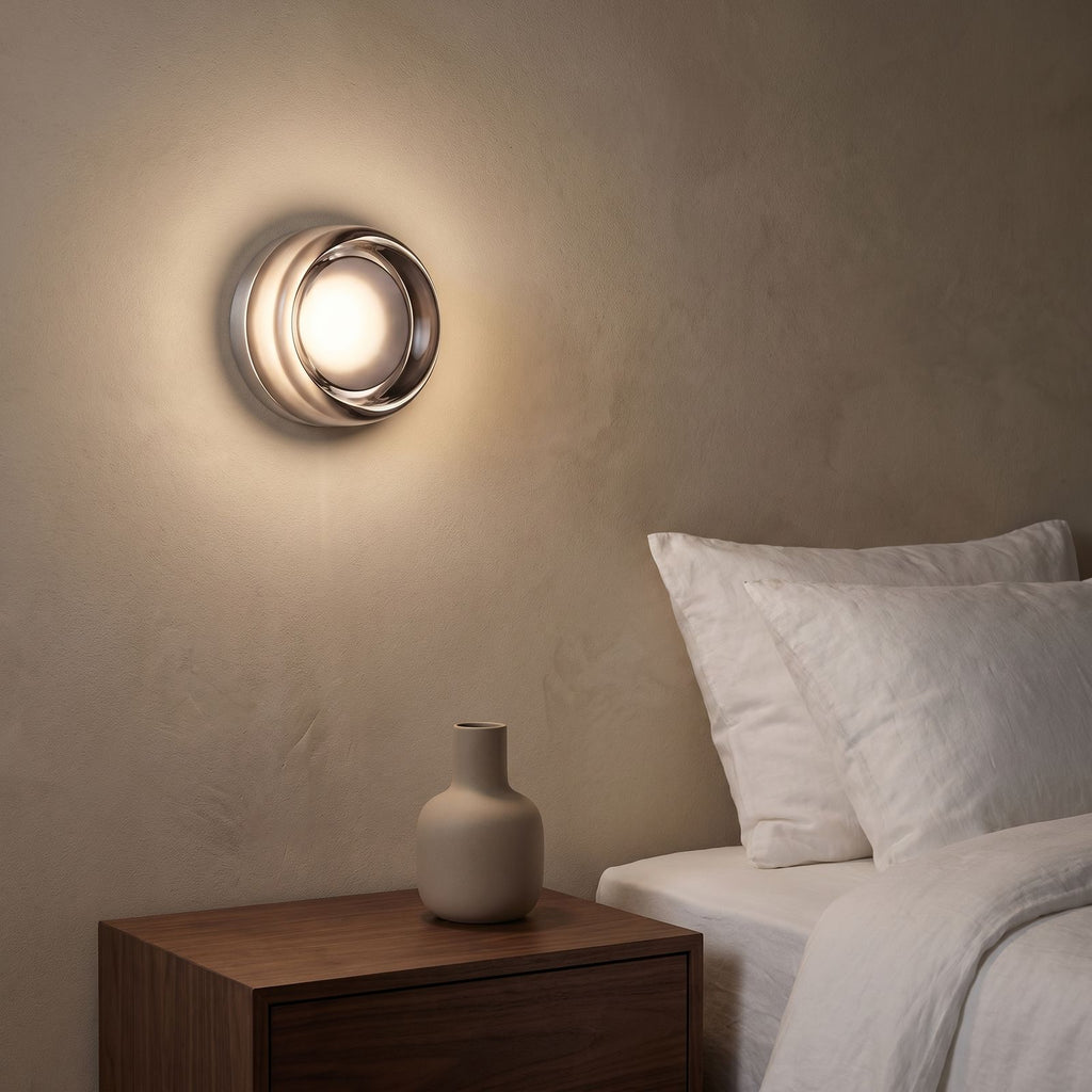 Smoked Dimple Glass LED Wall Light beside a bed at night