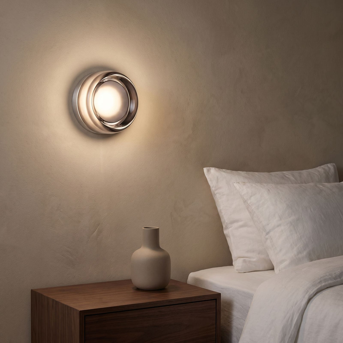 Smoked Dimple Glass LED Wall Light beside a bed at night