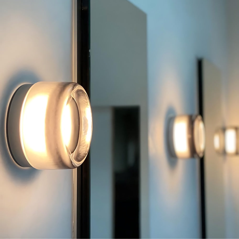 Side view of a glowing dimple glass wall light showing its depth
