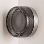 Smoked Dimple Glass LED Wall Light on a plaster wall in daylight