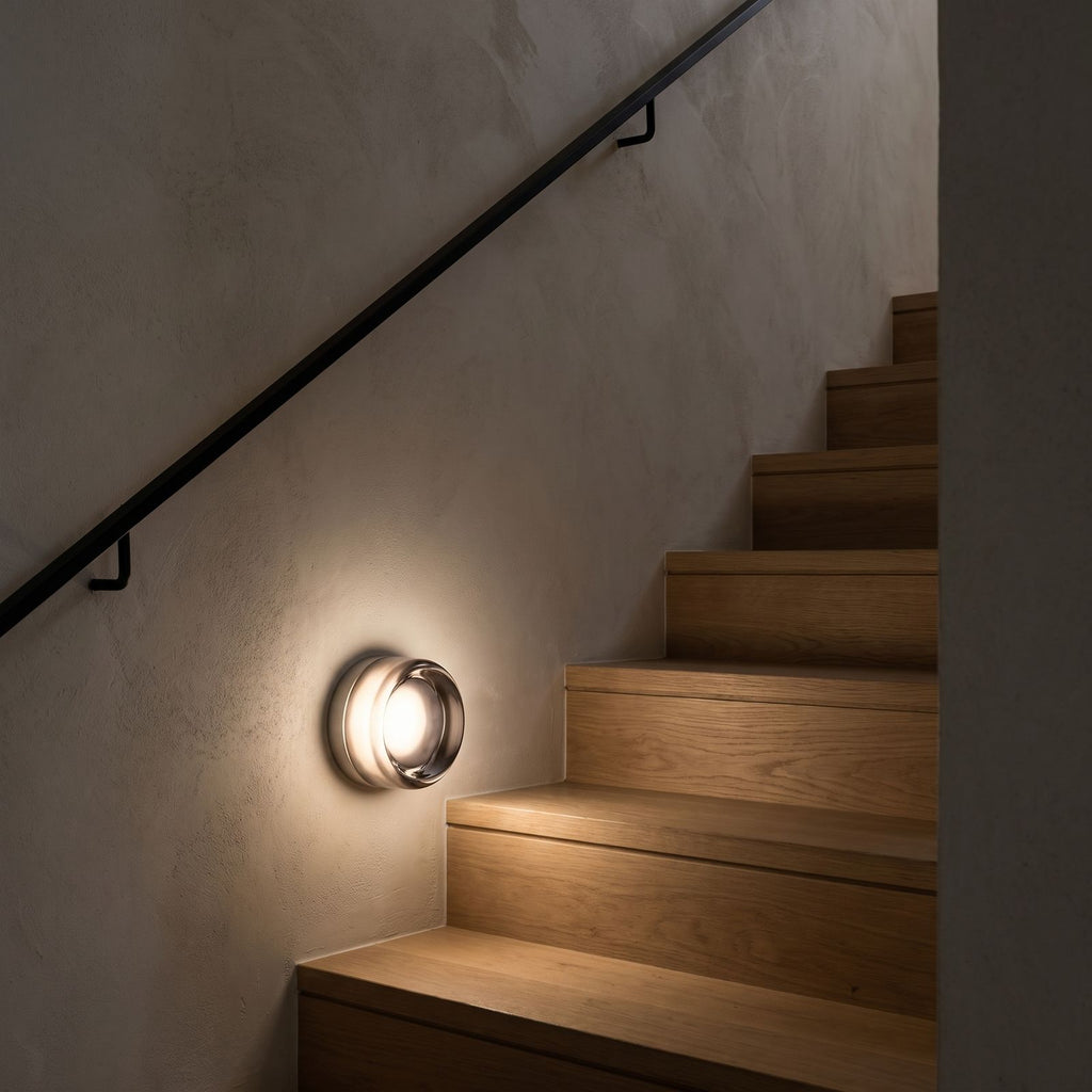 Smoked Dimple Glass LED Wall Light beside a staircase at night