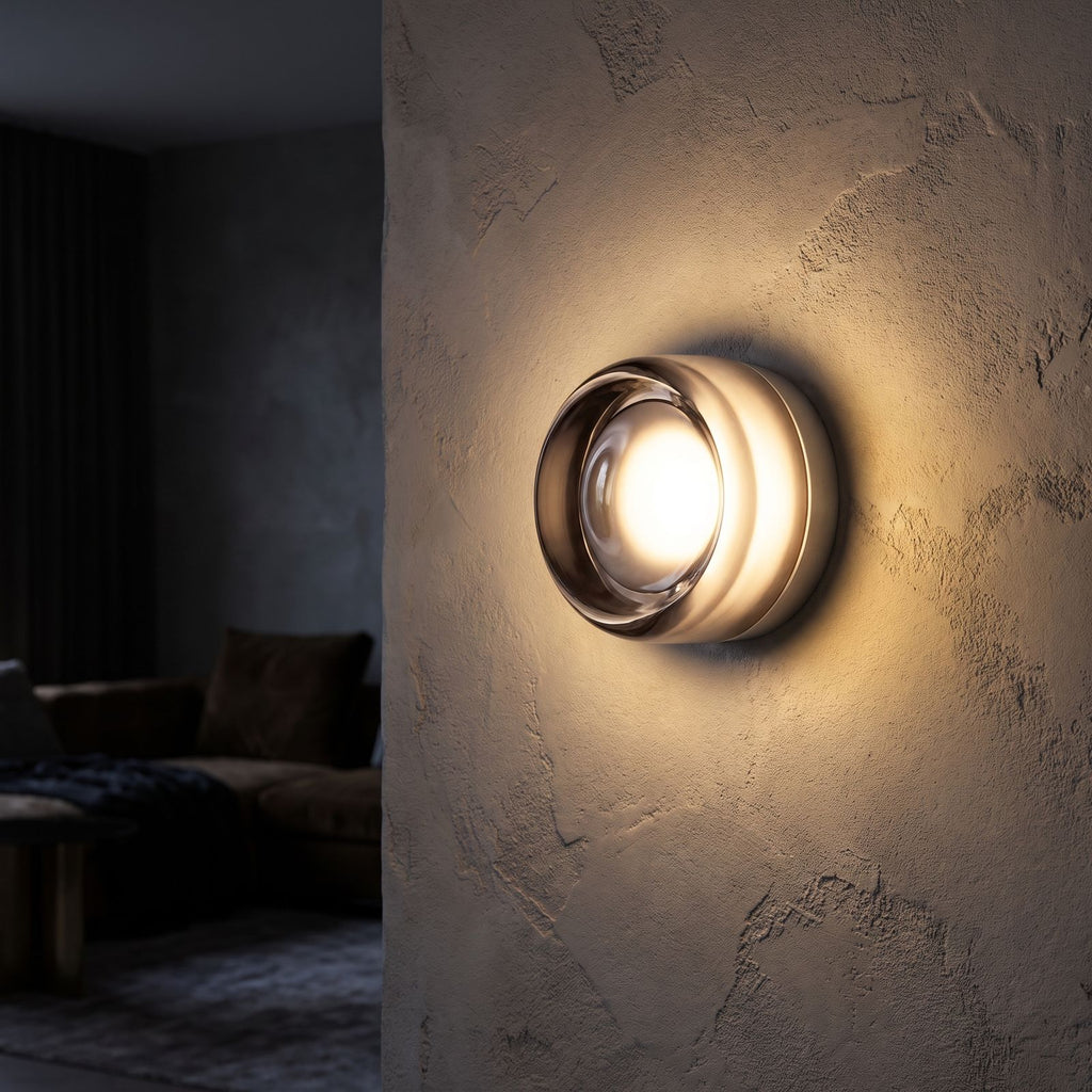 Smoked Dimple Glass LED Wall Light glowing on a limewashed wall at night