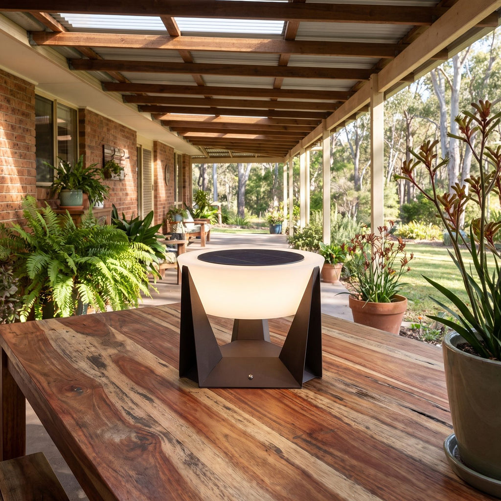 Solar Iron and Acrylic Outdoor Table Lamp on an outdoor table on a covered patio