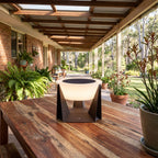 Solar Iron and Acrylic Outdoor Table Lamp on an outdoor table on a covered patio