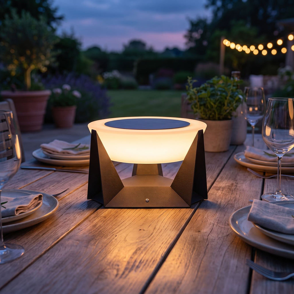 Solar Iron and Acrylic Outdoor Table Lamp on an alfresco dining table at dusk