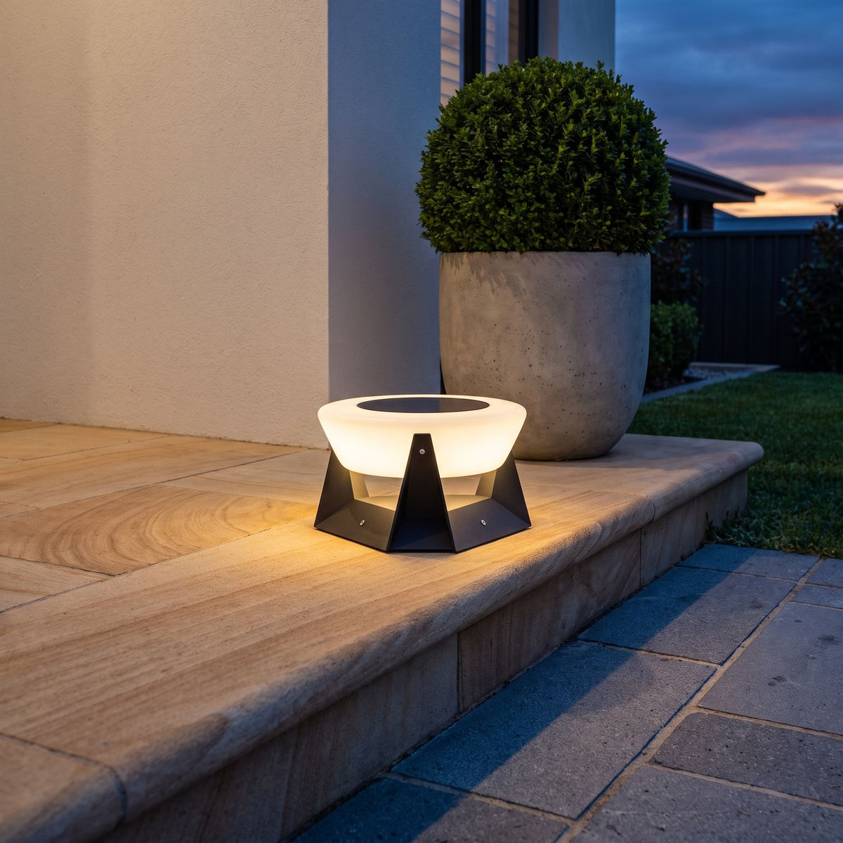 Solar LED Bowl Garden Light on a sandstone entry step at dusk