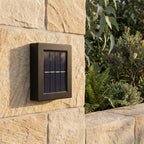 Solar Up Down Outdoor Wall Light, close view at 45 degrees on a stone wall