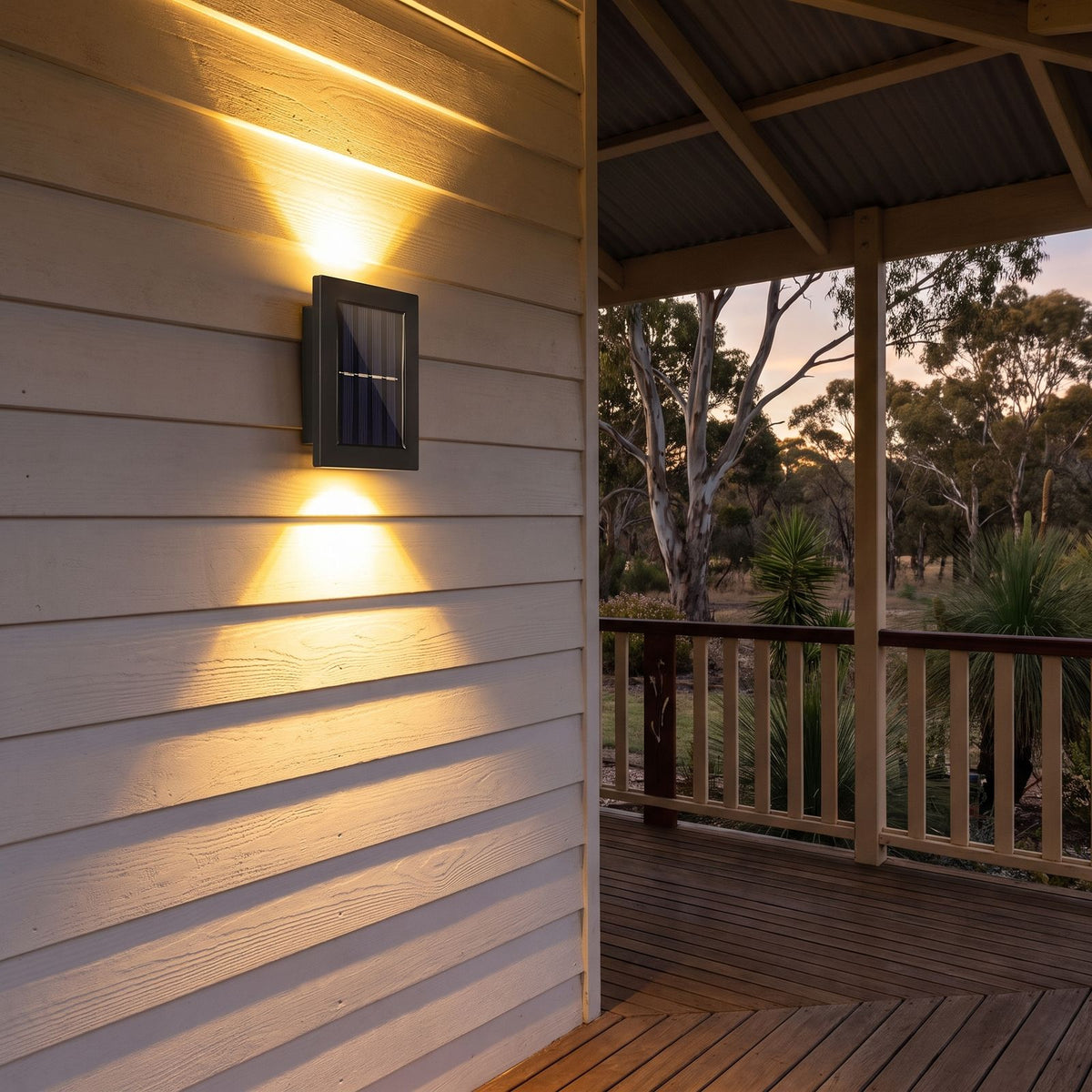Solar Up Down Outdoor Wall Light on a porch wall at dusk