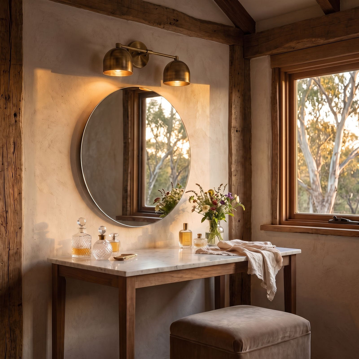 Solid Brass Double Dome Vanity Wall Light in vintage brass, above the mirror of a dressing table