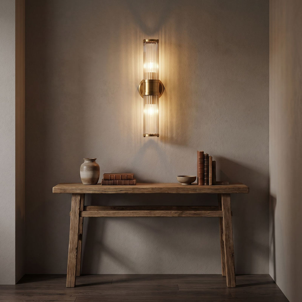 Ribbed Crystal Glass Tube Gold Wall Light with two tubes in a hallway above a timber console