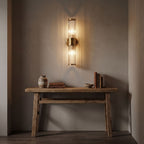 Ribbed Crystal Glass Tube Gold Wall Light with two tubes in a hallway above a timber console