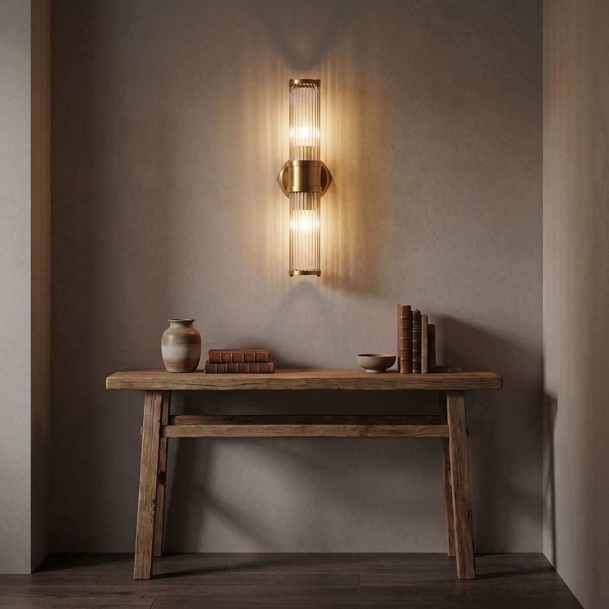 Ribbed Crystal Glass Tube Gold Wall Light with two tubes in a hallway above a timber console