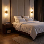 Pair of Ribbed Crystal Glass Tube Gold Wall Lights with two tubes above bedside tables in a bedroom at night