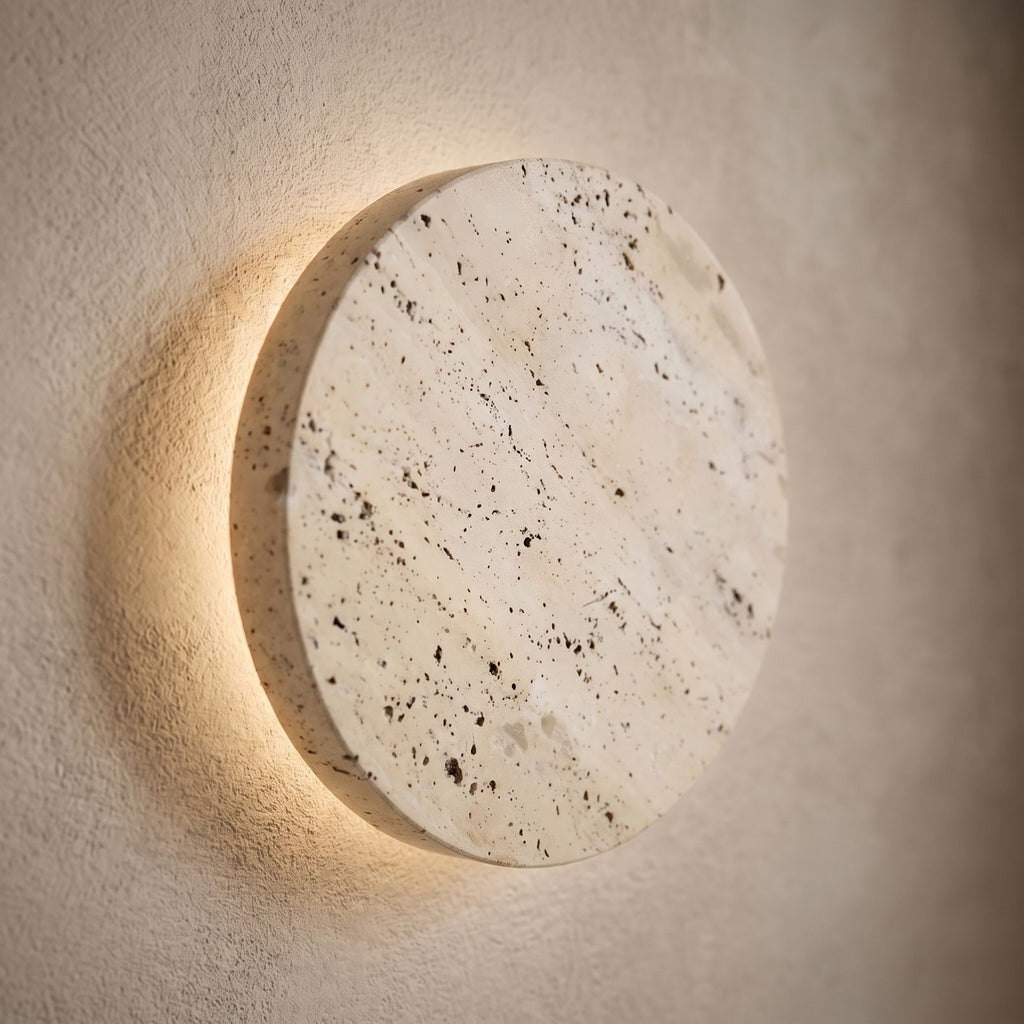 Solid Yellow Travertine Round LED Wall Light, close view at 45 degrees on a plaster wall