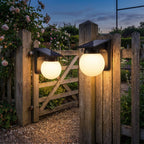 Spherical Solar Outdoor Wall Light on a porch wall at dusk