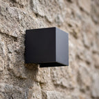 Square Adjustable Beam LED Outdoor Wall Light, close view at 45 degrees on a stone wall