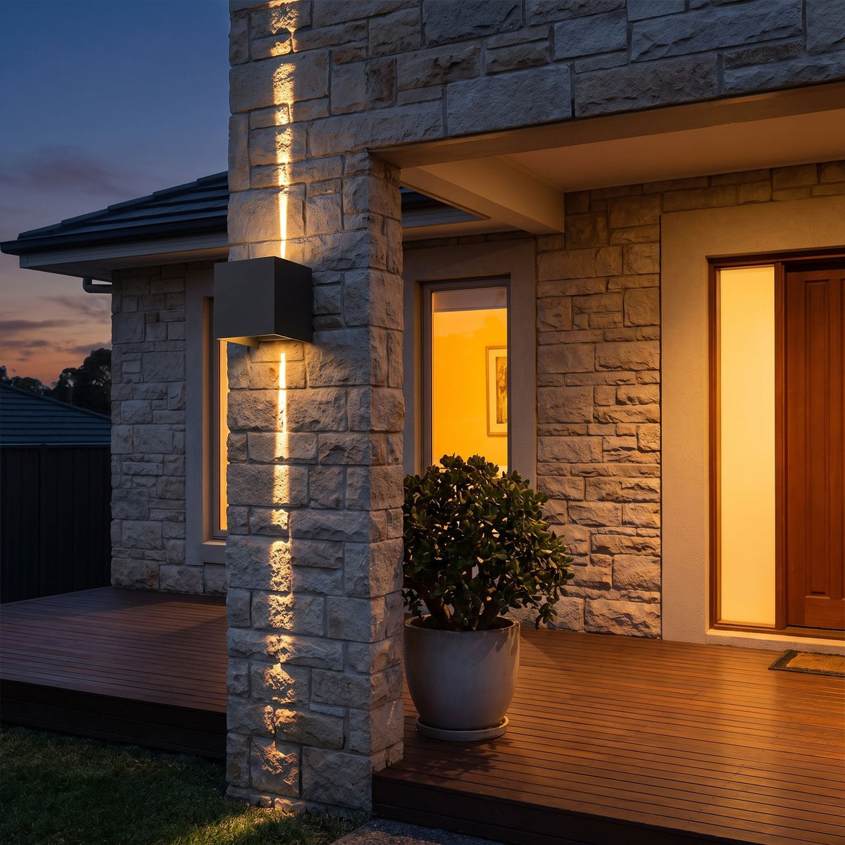 Square Adjustable Beam LED Outdoor Wall Light on a porch wall at dusk