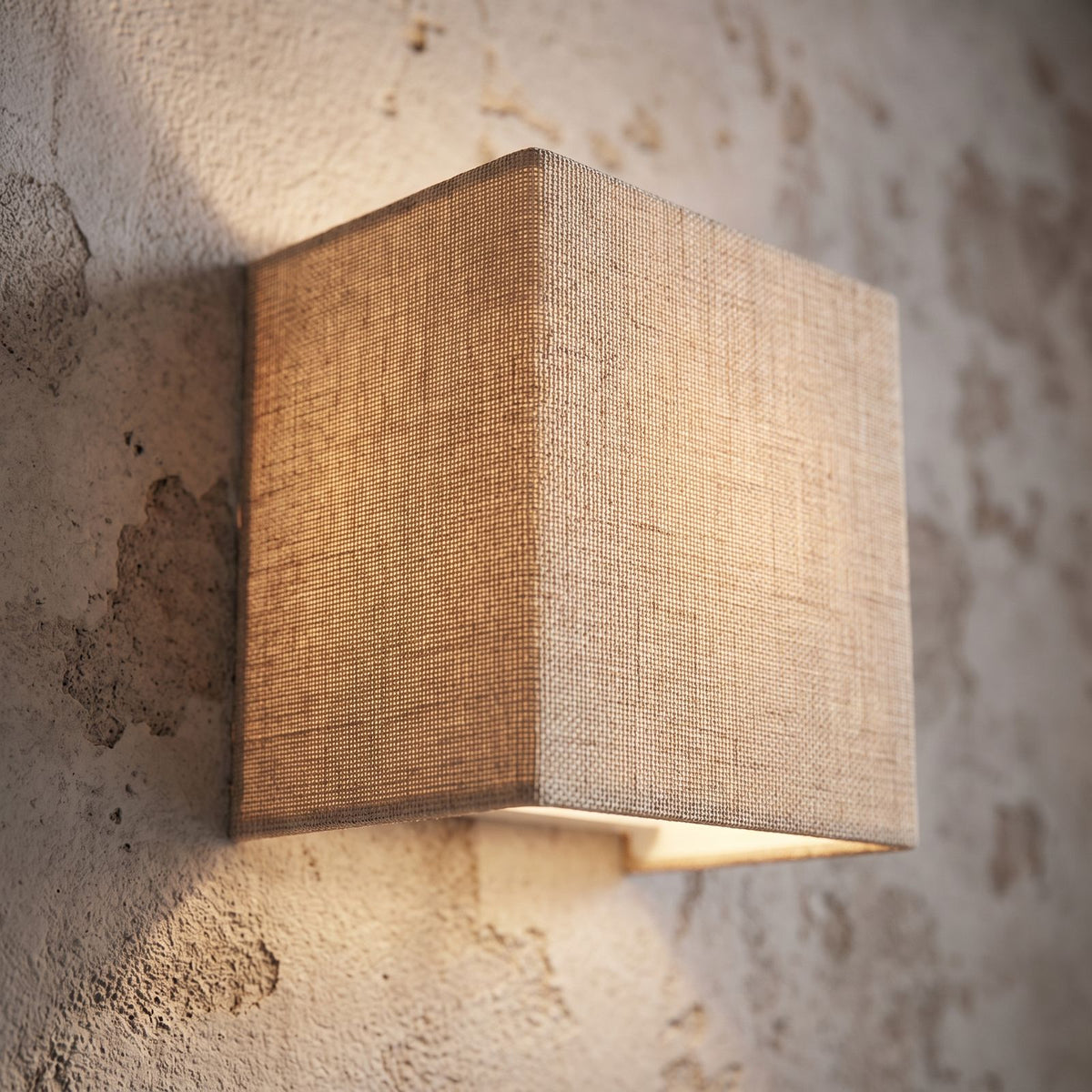 Square Beige Fabric Shade Wall Light, close view at 45 degrees on a plaster wall