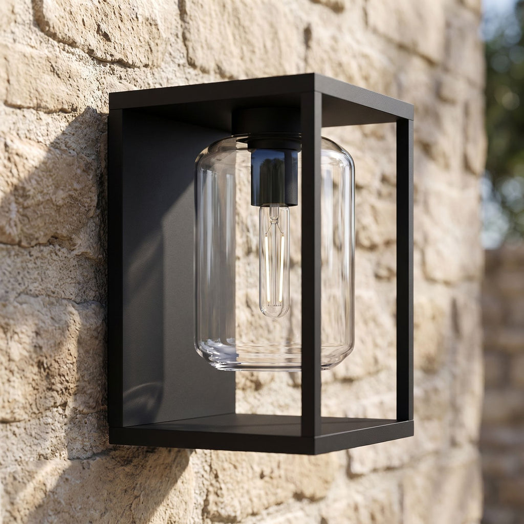 Square Frame Glass Outdoor Wall Lantern, close view at 45 degrees on a stone wall