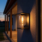 Square Frame Glass Outdoor Wall Lantern on a porch wall at dusk
