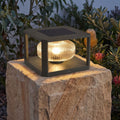 Square Frame Ribbed Glass Pillar Solar Garden Light on a sandstone gate pillar at dusk