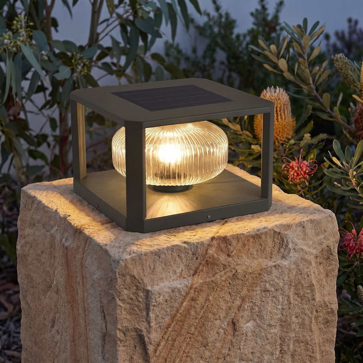 Square Frame Ribbed Glass Pillar Solar Garden Light on a sandstone gate pillar at dusk