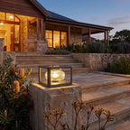 Square frame solar pillar light on a stone pier beside patio steps