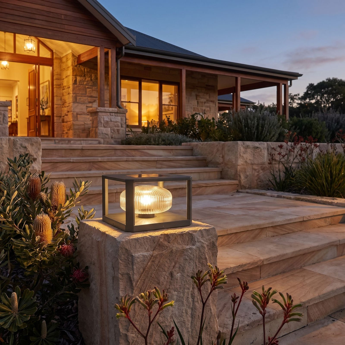 Square frame solar pillar light on a stone pier beside patio steps