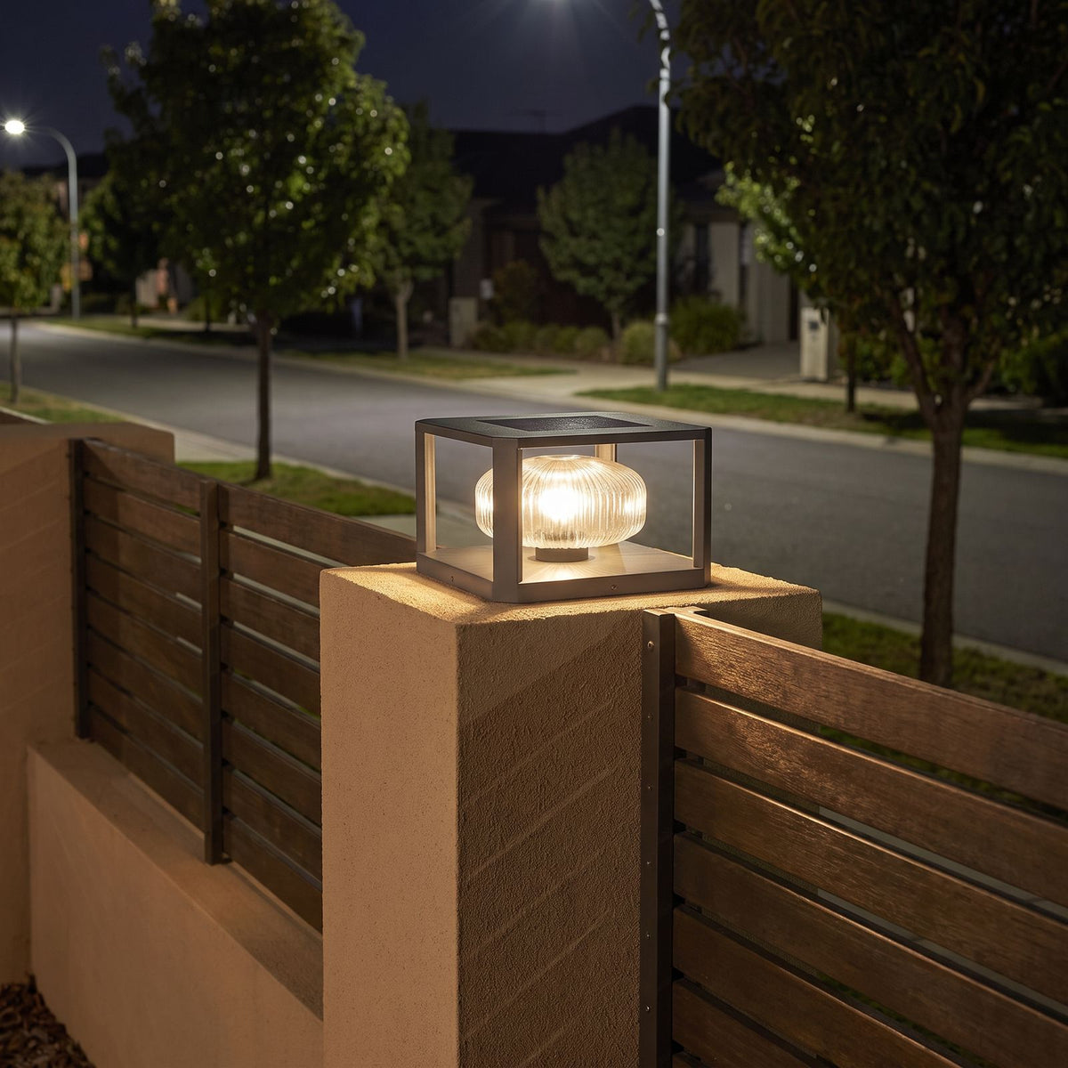 Square frame solar pillar light on a front fence pier at night