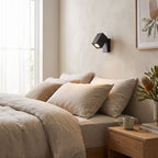 Square Head Rotatable Metal Spotlight Wall Light on a bedroom wall beside the bed