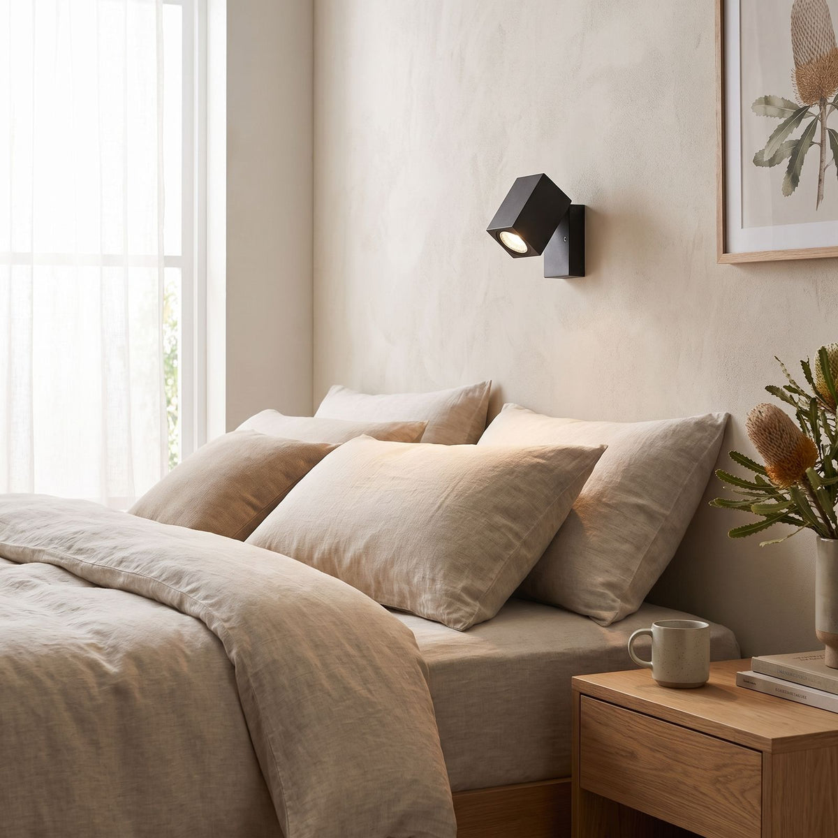 Square Head Rotatable Metal Spotlight Wall Light on a bedroom wall beside the bed