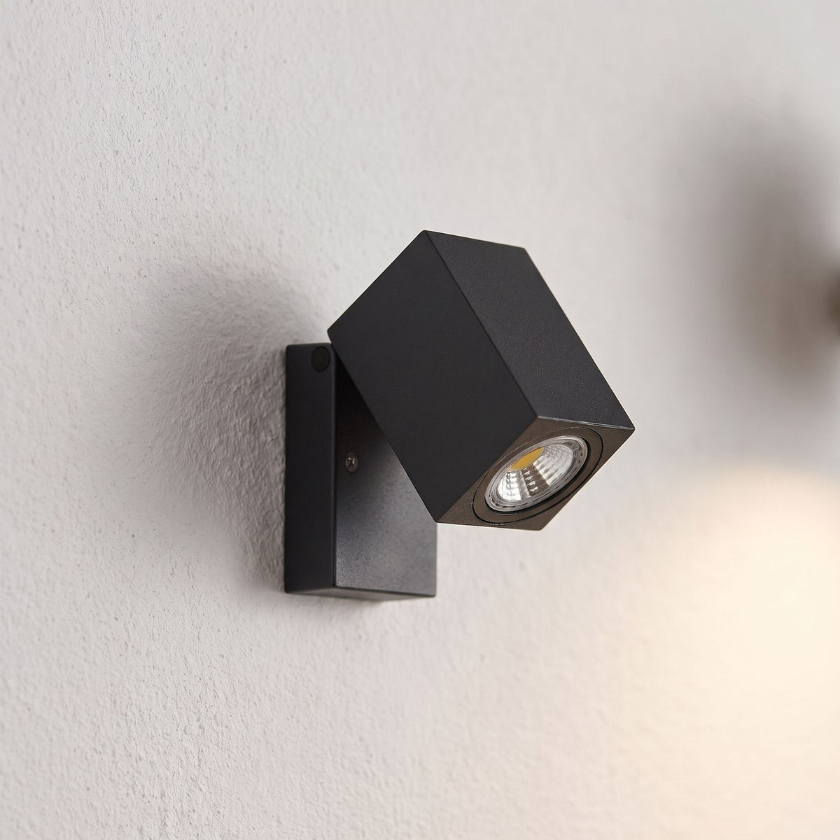 Square Head Rotatable Metal Spotlight Wall Light, close view at 45 degrees on a plaster wall