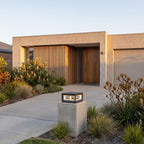 Square Stainless Steel Window Frame LED Post Light at the driveway entrance, wide view of the house