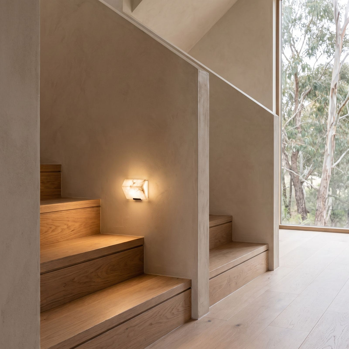 Stacked Alabaster Block Stair Wall Light on a bedroom wall beside the bed