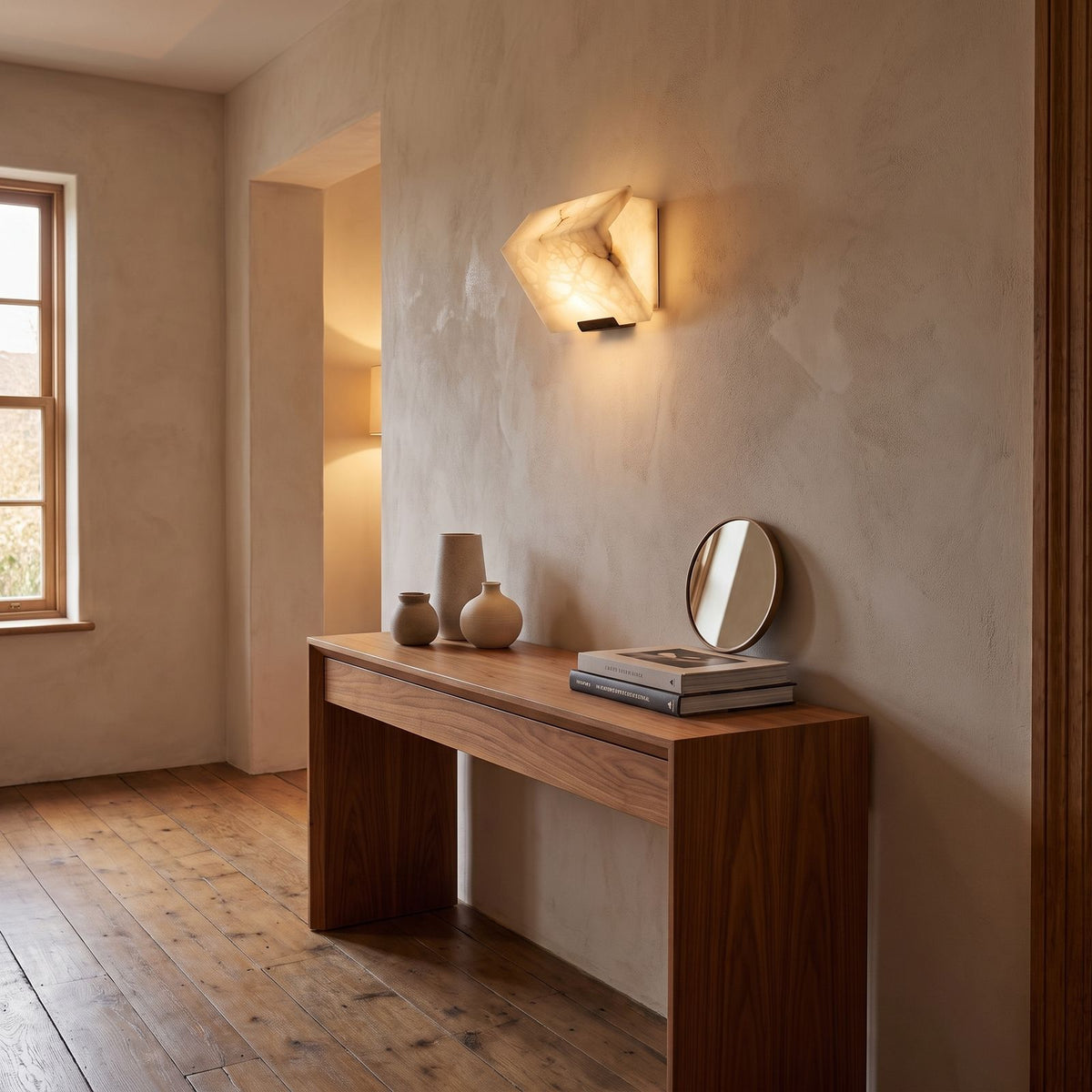 Stacked Alabaster Block Stair Wall Light in a hallway above a timber console